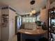 Well-lit kitchen features modern appliances, ample storage, and breakfast bar seating at 12021 Club House Rd, Brooksville, FL 34613