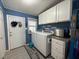 Functional laundry room with washer, dryer, and ample cabinet space at 12021 Club House Rd, Brooksville, FL 34613