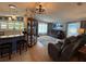 Cozy living room with plush seating, a display cabinet, and a scenic view from the bright windows at 12021 Club House Rd, Brooksville, FL 34613