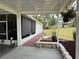Covered patio area with outdoor seating and views of the landscaped backyard at 12021 Club House Rd, Brooksville, FL 34613