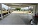 Covered patio area with manicured flowerbeds, concrete flooring and decorative features at 12021 Club House Rd, Brooksville, FL 34613