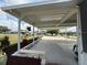 Open patio showcasing a covered area, manicured flowerbeds, decorative plants, and concrete flooring at 12021 Club House Rd, Brooksville, FL 34613
