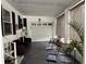 Relaxing screened porch with comfortable seating, garage access, and privacy shades at 12021 Club House Rd, Brooksville, FL 34613