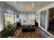 Bright sunroom with plentiful windows, comfortable seating, and a peaceful ambiance at 12021 Club House Rd, Brooksville, FL 34613