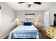 Bright bedroom showcasing hardwood floors, a ceiling fan, and ample natural light at 1205 Desert Hills Dr, Sun City Center, FL 33573