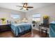 Cozy bedroom with hardwood floors, a ceiling fan and natural lighting at 1205 Desert Hills Dr, Sun City Center, FL 33573
