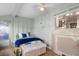 Cozy bedroom with a decorative fireplace, light green walls, a ceiling fan, and a decorative bench at 1205 Desert Hills Dr, Sun City Center, FL 33573