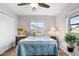 Inviting bedroom featuring a comfortable bed, natural light, and wood-look floors at 1205 Desert Hills Dr, Sun City Center, FL 33573