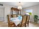 Elegant dining room with chandelier, dining table set, and display cabinet at 1205 Desert Hills Dr, Sun City Center, FL 33573