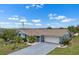 Beautiful blue home with a well-maintained lawn and gray driveway at 1205 Desert Hills Dr, Sun City Center, FL 33573
