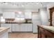 Well-lit kitchen with white cabinetry, neutral countertops, and modern appliances at 1205 Desert Hills Dr, Sun City Center, FL 33573