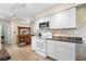 Well-lit kitchen boasting updated appliances and white cabinetry at 1205 Desert Hills Dr, Sun City Center, FL 33573