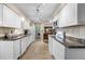 A bright kitchen with white cabinets and appliances offering functionality and style at 1205 Desert Hills Dr, Sun City Center, FL 33573