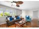 Bright living space with wood floors, large windows, and comfortable sofa at 1205 Desert Hills Dr, Sun City Center, FL 33573