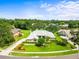 Gorgeous aerial view of home showcasing manicured lawn, mature landscaping and circular driveway situated among lush greenery at 13608 Lytton Way, Tampa, FL 33624