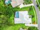 Birds-eye view features a home with an enclosed pool, manicured yard and mature trees at 13608 Lytton Way, Tampa, FL 33624