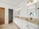Bright bathroom featuring a double vanity and walk-in shower with tiled walls at 13608 Lytton Way, Tampa, FL 33624