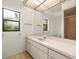 Bright bathroom featuring a long vanity with a sink, a large mirror, and a shower at 13608 Lytton Way, Tampa, FL 33624