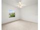 Bedroom with carpet floors, ceiling fan, and a window providing natural light at 13608 Lytton Way, Tampa, FL 33624