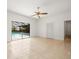 Open bedroom with tile flooring, closet, and sliding glass door to the pool and lanai at 13608 Lytton Way, Tampa, FL 33624