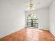 Bedroom featuring tile floors, a ceiling fan, and decorative window at 13608 Lytton Way, Tampa, FL 33624