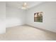 Bedroom features carpeted floors, a ceiling fan, and a bright window view at 13608 Lytton Way, Tampa, FL 33624