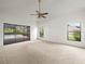 Bedroom with carpeted flooring and sliding glass doors leading to a screened in pool area at 13608 Lytton Way, Tampa, FL 33624
