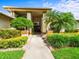 Charming front entrance with manicured landscaping, a welcoming walkway, and double front doors at 13608 Lytton Way, Tampa, FL 33624