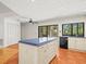 Spacious kitchen with an island, tiled countertops, and stainless steel appliances at 13608 Lytton Way, Tampa, FL 33624