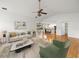 Open-concept living room boasts hardwood floors, bright white walls, and a seamless flow into the kitchen at 13608 Lytton Way, Tampa, FL 33624