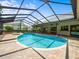 Screened-in pool area with brick pavers, providing a relaxing outdoor space at 13608 Lytton Way, Tampa, FL 33624