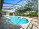 Inviting pool area with screened enclosure perfect for relaxation and entertainment; includes attached jacuzzi at 13608 Lytton Way, Tampa, FL 33624