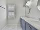 Bathroom with double vanity, marble countertop, and plantation shutters at 1402 Harbour Walk Rd, Tampa, FL 33602