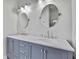 Elegant bathroom featuring a double sink vanity with marble countertop and modern fixtures at 1402 Harbour Walk Rd, Tampa, FL 33602