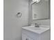 Bathroom featuring a vanity with a white cabinet and sink, a chrome faucet, a mirror, and a towel ring against neutral walls at 1402 Harbour Walk Rd, Tampa, FL 33602