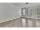 Light-filled bedroom with beautiful hardwood flooring and shuttered windows at 1402 Harbour Walk Rd, Tampa, FL 33602