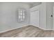 Well-lit bedroom with hardwood floors, window with shutters, and closet at 1402 Harbour Walk Rd, Tampa, FL 33602