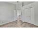Bedroom with hardwood floors, closet, and stairway access at 1402 Harbour Walk Rd, Tampa, FL 33602