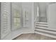 Elegant entryway featuring staircase and natural light from shuttered windows at 1402 Harbour Walk Rd, Tampa, FL 33602