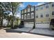 Townhome exterior with a two-car garage, elegant arched windows, and well-maintained landscaping at 1402 Harbour Walk Rd, Tampa, FL 33602