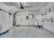 Clean garage featuring epoxy floor, water heater, and white storage cabinets at 1402 Harbour Walk Rd, Tampa, FL 33602