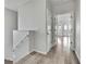 Hallway with natural light and wood-look flooring leading to additional rooms at 1402 Harbour Walk Rd, Tampa, FL 33602