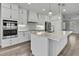 Well-designed kitchen with stainless steel appliances, white cabinets, and a marble countertop island at 1402 Harbour Walk Rd, Tampa, FL 33602