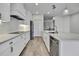Elegant kitchen featuring a large island, sleek appliances, and white cabinetry at 1402 Harbour Walk Rd, Tampa, FL 33602