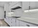 Elegant kitchen with a modern cooktop, white cabinetry, and sleek countertops at 1402 Harbour Walk Rd, Tampa, FL 33602