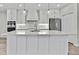 Modern kitchen features a large island, pendant lighting, and sleek white cabinets at 1402 Harbour Walk Rd, Tampa, FL 33602