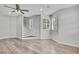 Bright living room with large windows, plantation shutters, and modern ceiling fan at 1402 Harbour Walk Rd, Tampa, FL 33602