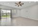 Living room featuring contemporary decor, a ceiling fan, tiled floors, and sliding glass doors that lead to a backyard area at 1402 Harbour Walk Rd, Tampa, FL 33602