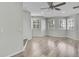 Living room featuring a ceiling fan, wood floors, and plantation shutters at 1402 Harbour Walk Rd, Tampa, FL 33602