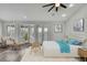 Bright bedroom with plantation shutters, ceiling fan, and ensuite doors at 1402 Harbour Walk Rd, Tampa, FL 33602